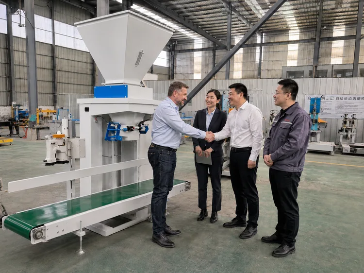 Group discussing an automatic granule bagging machine in a workshop