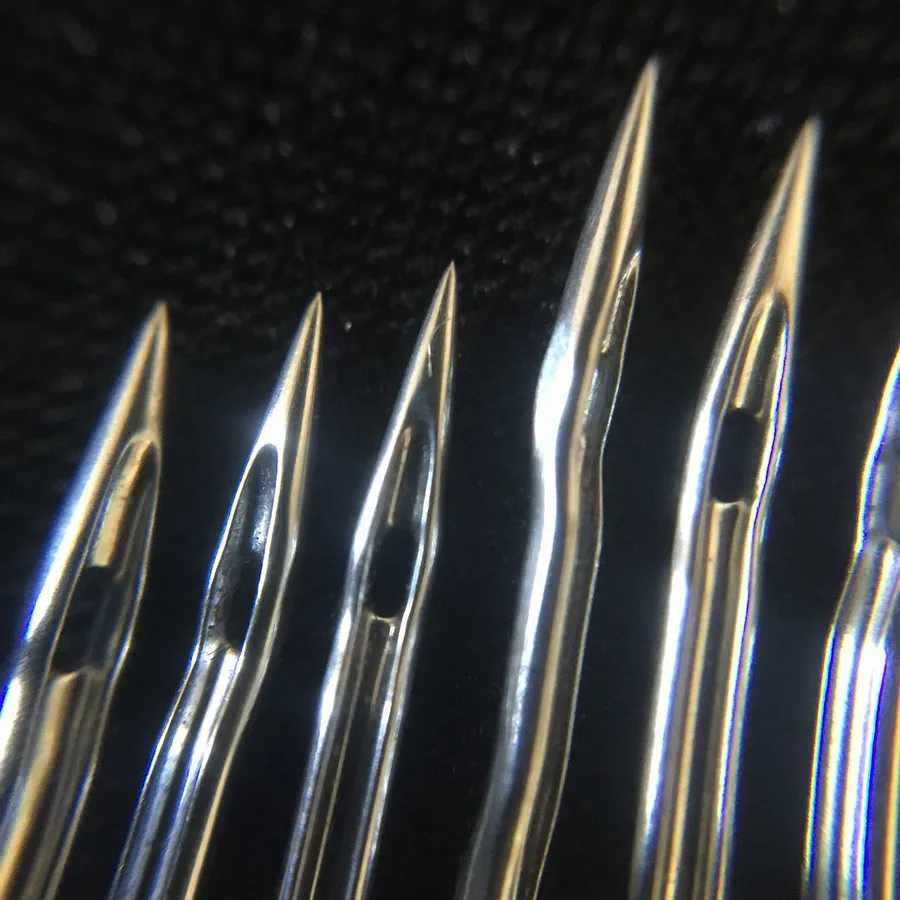 Close-up view of industrial sewing machine needle tips
